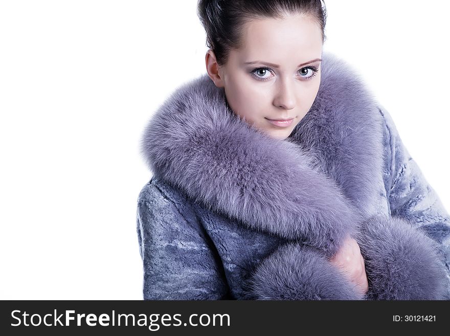 Portrait of beautiful face and impressive eyes brunette woman smiling, wearing luxury, warm, winter fur mink coat. Shot in studio. Isolated on white. Portrait of beautiful face and impressive eyes brunette woman smiling, wearing luxury, warm, winter fur mink coat. Shot in studio. Isolated on white.