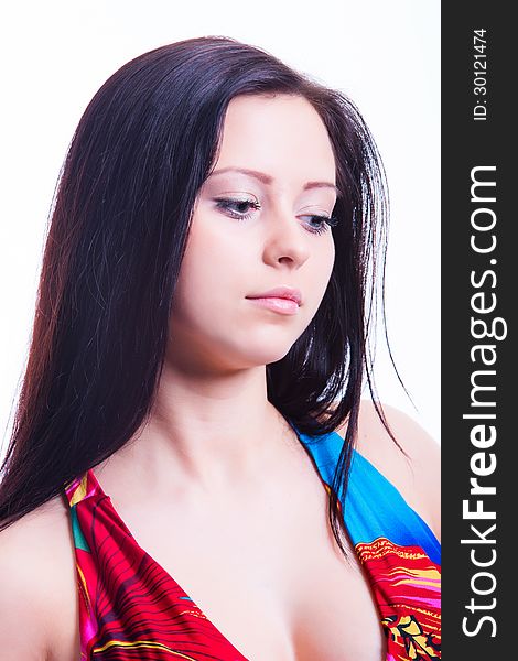 Portrait of beautiful face, long dark hair girl with decollete, looking down. Shot in studio. Isolated over white. Portrait of beautiful face, long dark hair girl with decollete, looking down. Shot in studio. Isolated over white.