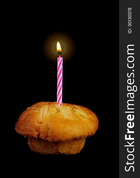 Birthday candle on the top of cupcake, black background. Birthday candle on the top of cupcake, black background.