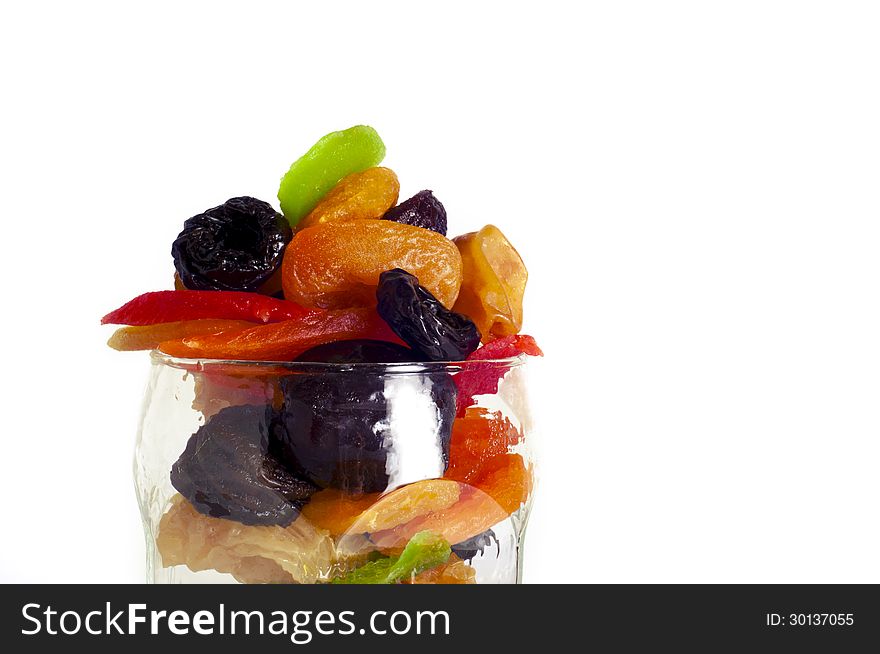 Dried fruits in a glass on a white background.close up