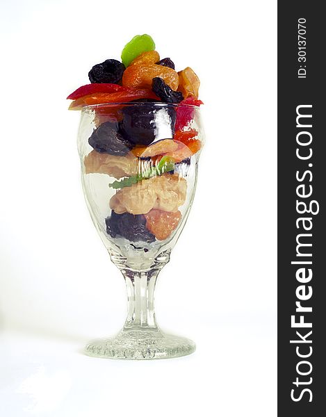 Dried fruits in a glass on a white background