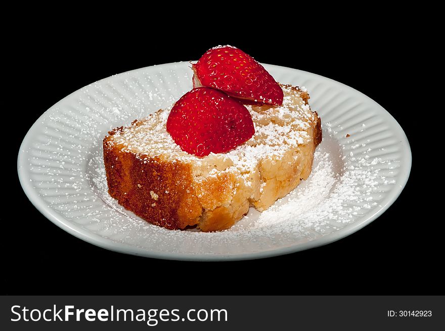 Pound cake with strawberry on black