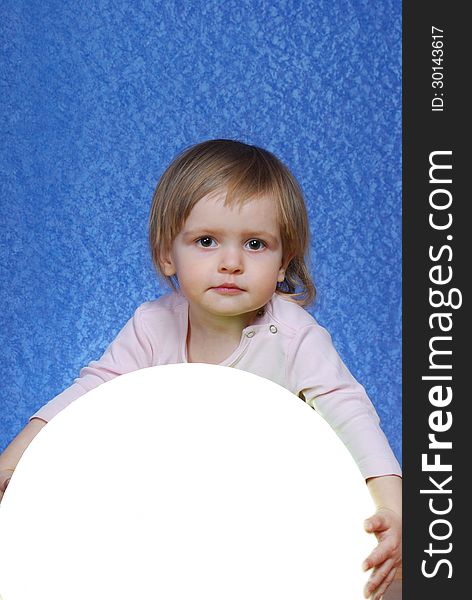 Child with ball, portrait on a blue background. This image has attached release.