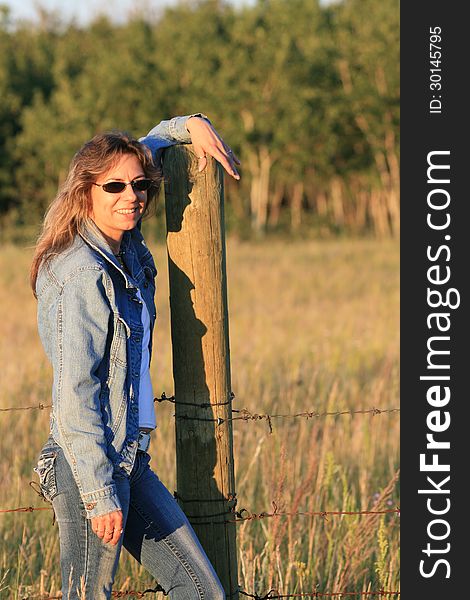 Country woman standing in front of a field