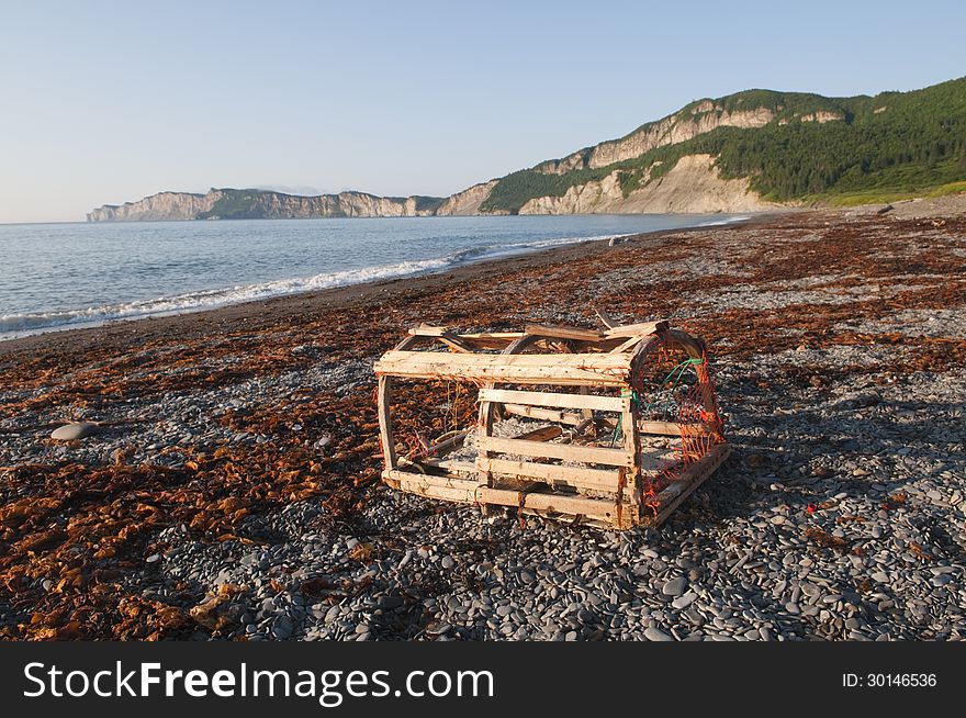 Morning light on a damaged lobster trap washed up onto the Gaspe shoreline. Morning light on a damaged lobster trap washed up onto the Gaspe shoreline