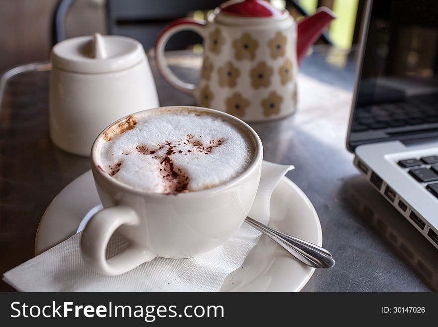 A cup of coffee and a laptop