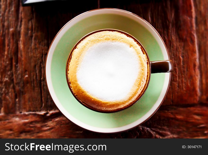 Fresh coffee cappuccino on wooden table