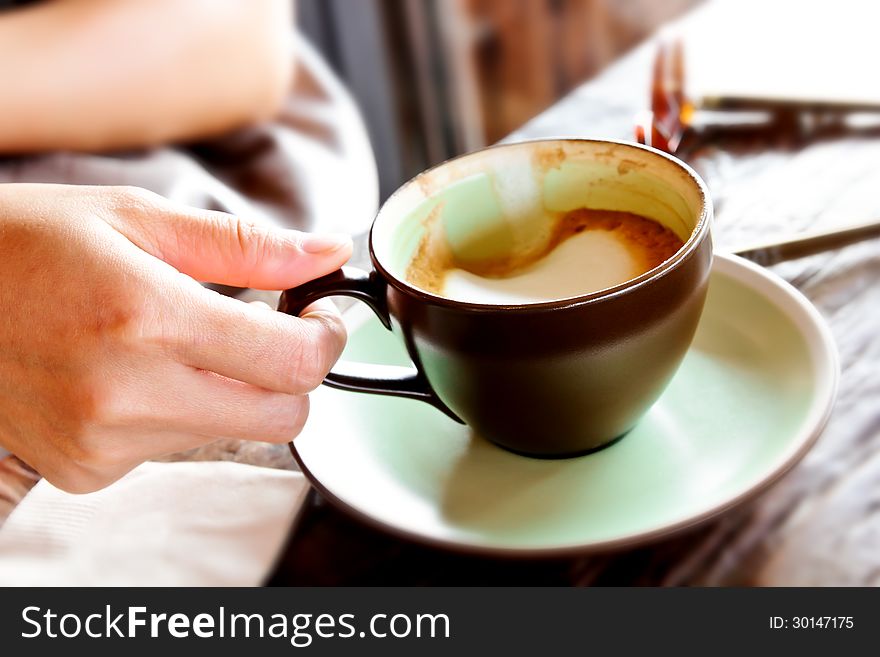 Female hand holding cup of coffee. Female hand holding cup of coffee