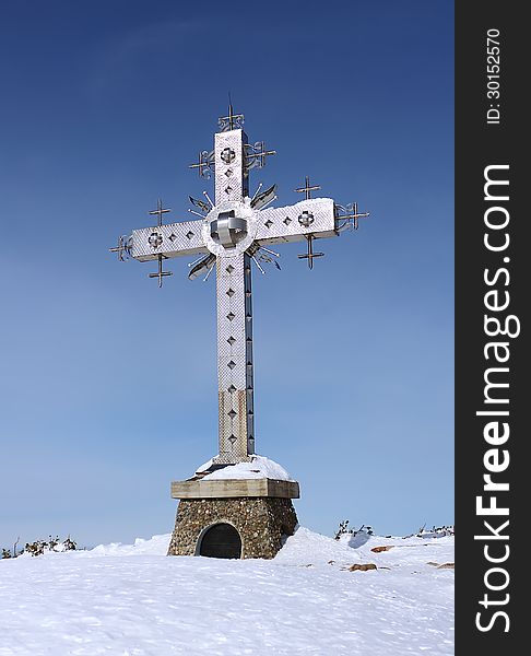 Cross on top of a mountain in the Sheregesh