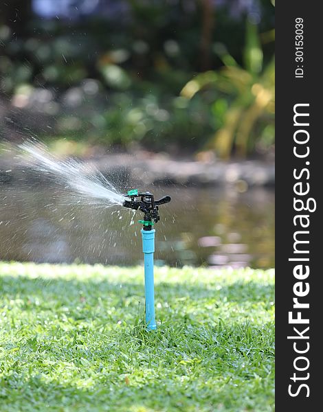 Photo of a Sprinkler in action on a water. Photo of a Sprinkler in action on a water.