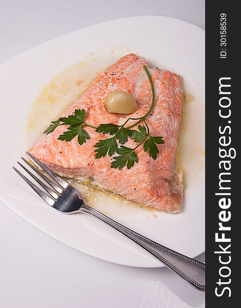 Roast salmon fillet with sauce, garlic and parsley