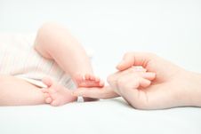 Little Baby Feet And Hand Of The Mother Royalty Free Stock Photography