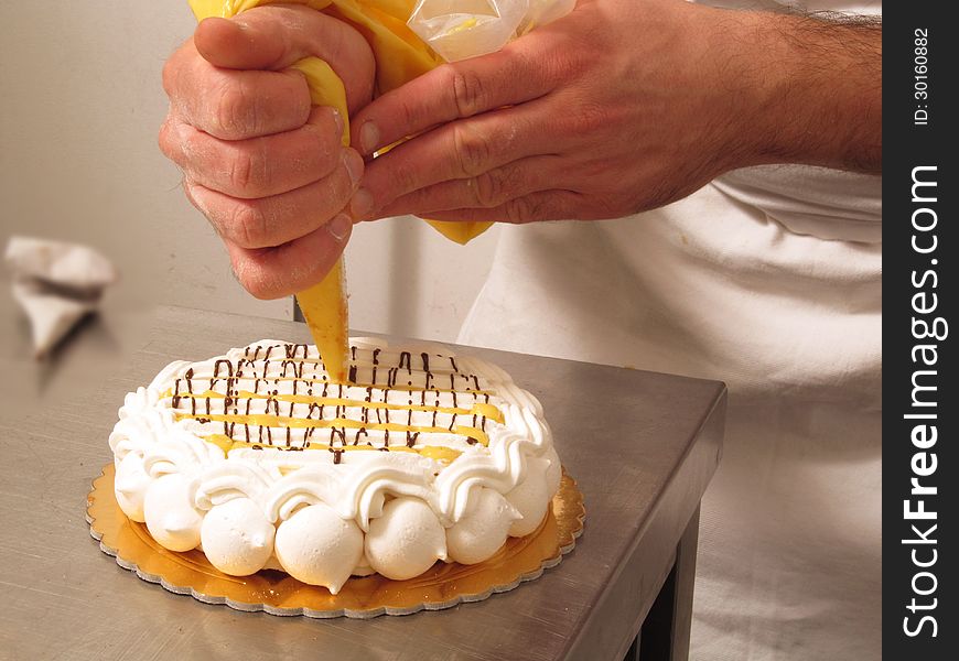 Chef hands preparing cream cake. Chef hands preparing cream cake.
