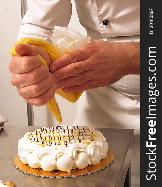 Chef hands preparing cream cake. Chef hands preparing cream cake.