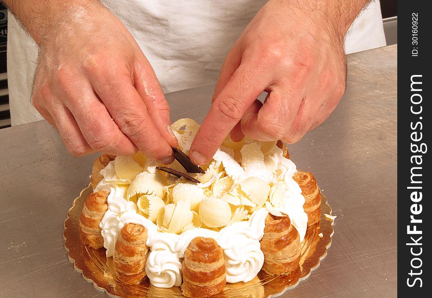 Chef hands preparing white cream cake. Chef hands preparing white cream cake.