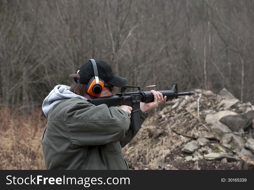 Man shooting rifle
