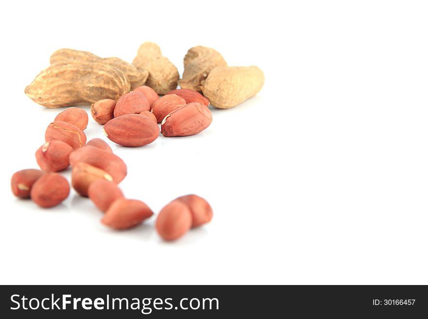 A lot of Peanuts on isolated over white background,focus on foreground. A lot of Peanuts on isolated over white background,focus on foreground