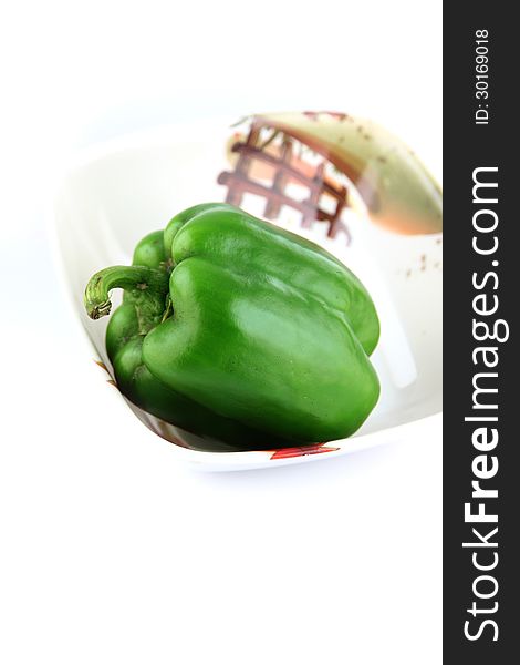 The Green Bell peppers in Dish on white Background. The Green Bell peppers in Dish on white Background.