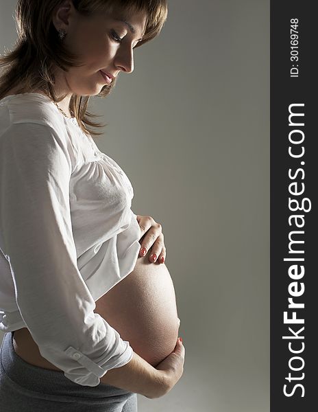 Young pregnant Woman Holding Belly