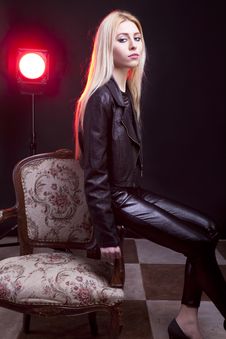 Girl In Leather Jacket With A Red Light Behind Royalty Free Stock Photos