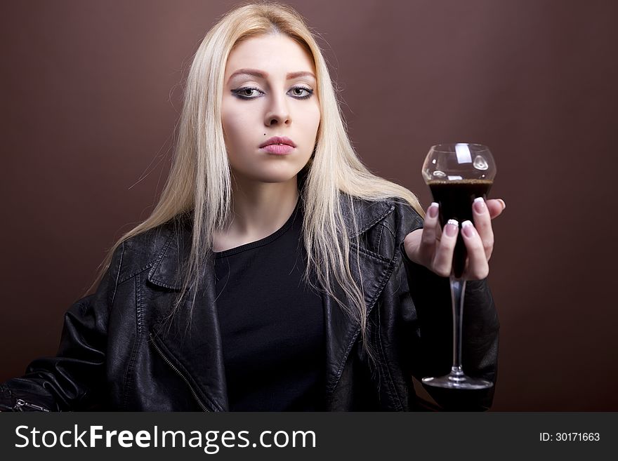 Portrait of beautiful caucasian girl with a glass in her hand studio shot