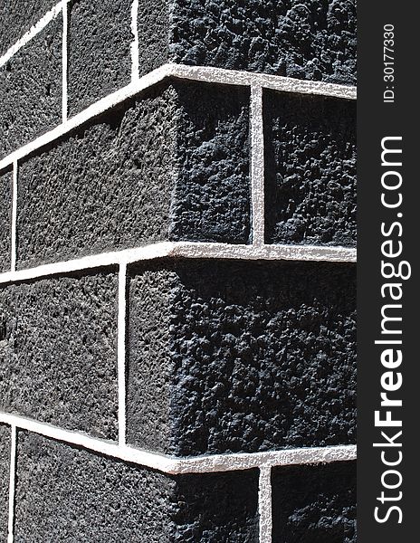 Stone background - a joint of two walls of a building from a large grey stone. Stone background - a joint of two walls of a building from a large grey stone.