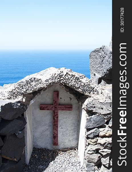 Wooden cross with the sea and the sky