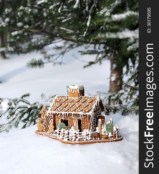 Gingerbread house in real snowy forest