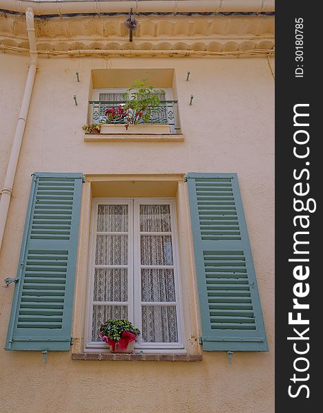 This image taken in Mougins, france was taken to show a typical french house with its typical Windows and shutters. This image taken in Mougins, france was taken to show a typical french house with its typical Windows and shutters.