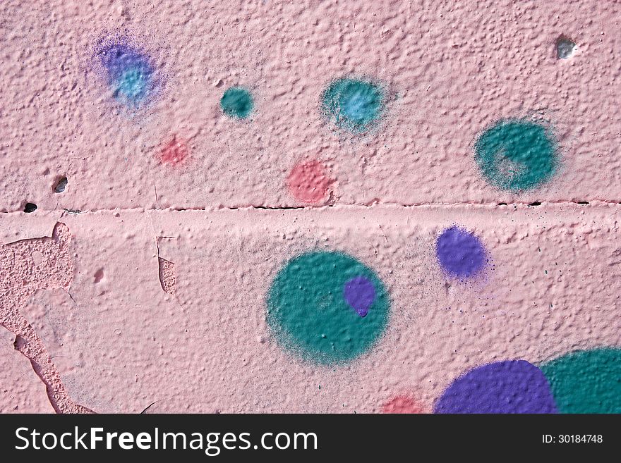 Colored polka dots on a pink wall. Colored polka dots on a pink wall