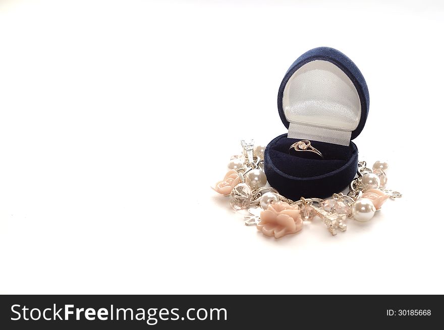 Gold ring in blue velvet gift box and necklace