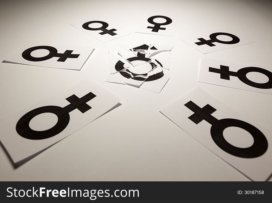 Concept of a man who loves to be with a lot of women, illustrated by white papers with gender symbols printed on it. Concept of a man who loves to be with a lot of women, illustrated by white papers with gender symbols printed on it.