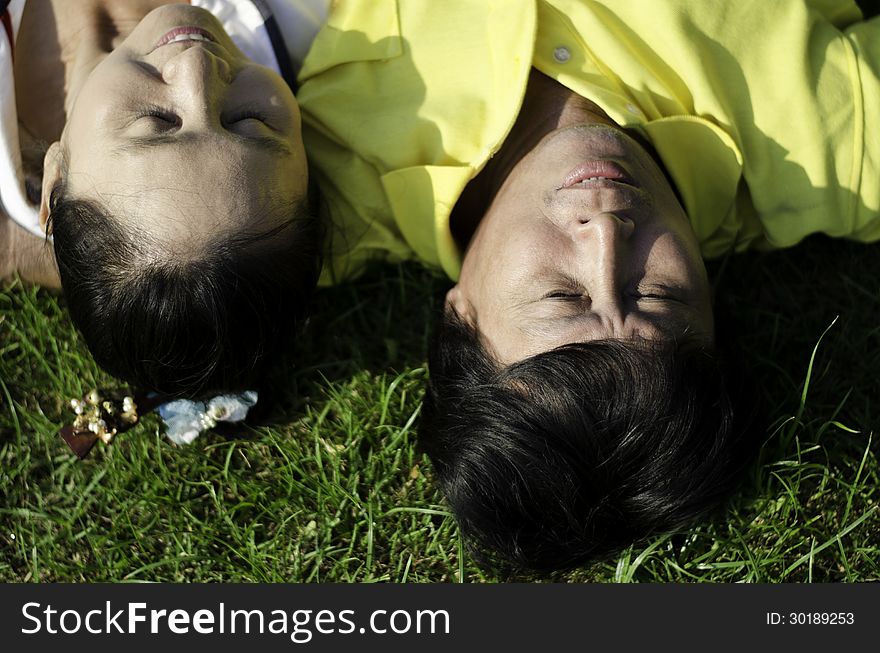 Seniors Couple Lying On Grass