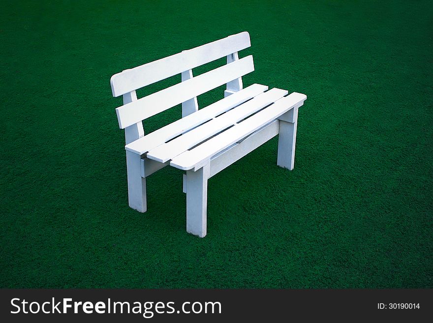 White bench on green field