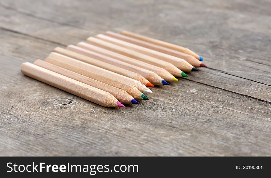 Coloring pencils on a wooden plane. Coloring pencils on a wooden plane