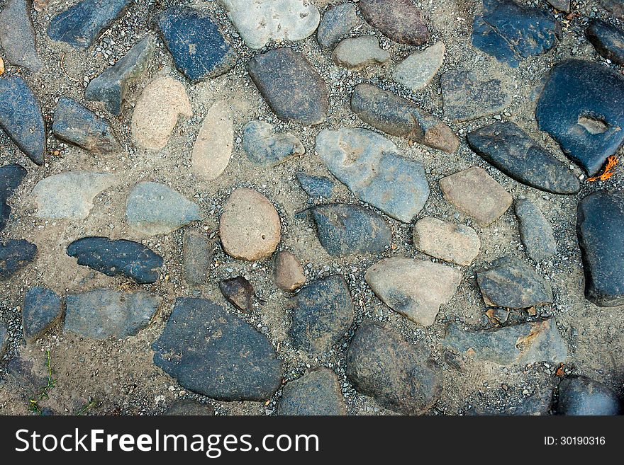 Irregular texture of the old blue gray stone wall outside