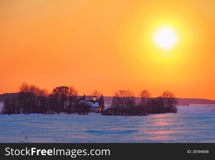 Lonely country house with a garden at sunset in late winter. Lonely country house with a garden at sunset in late winter