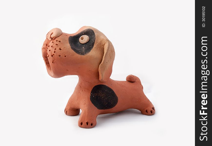 Dog baked clay sculpture on white background
