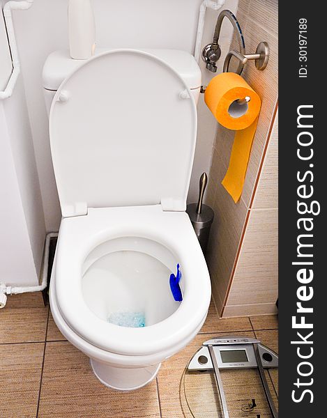 White Toilet with orange paper