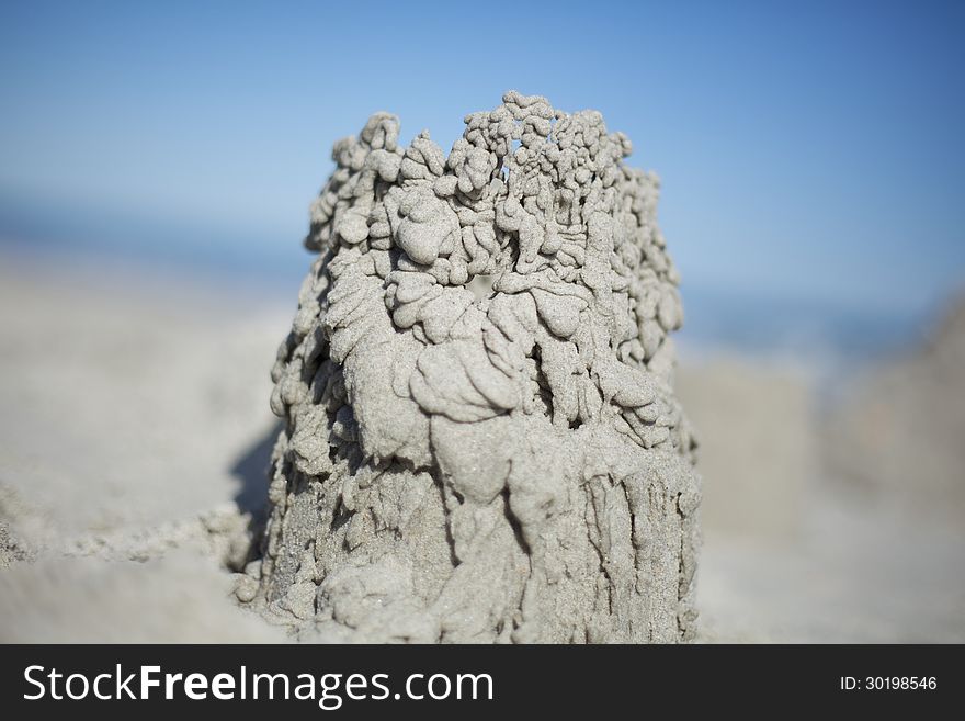 Sand castle dribble on a beach.