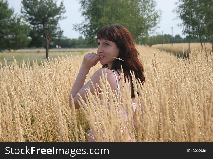 Young girl in standing the wheat field