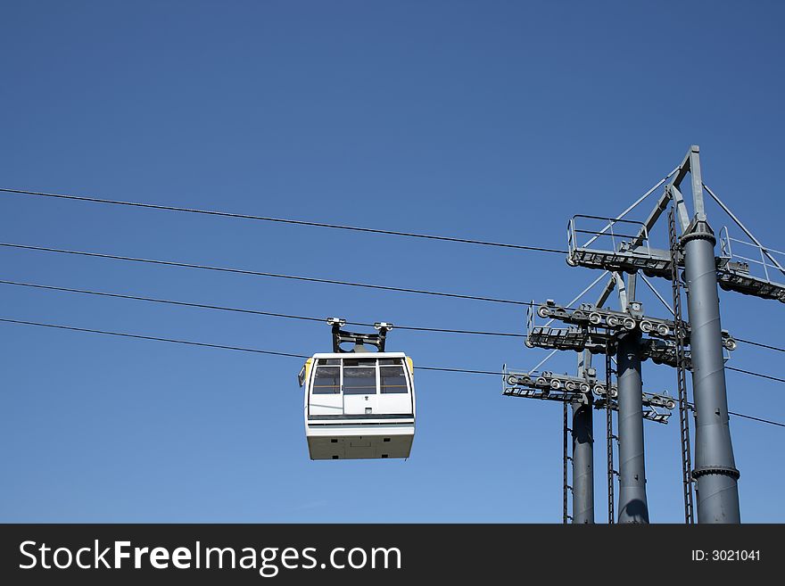 White cable car going up to the mountain.