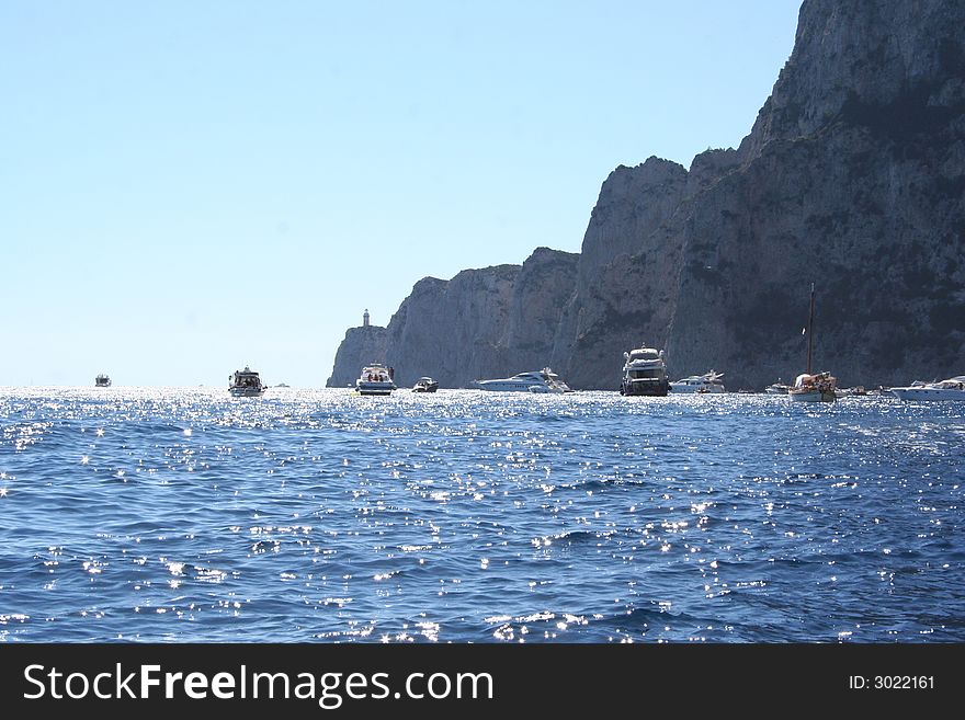 Capri Island in Italy Europe / Crystal-clear water, boats and enchanting rock. Capri Island in Italy Europe / Crystal-clear water, boats and enchanting rock