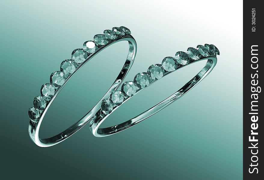 Two rings with diamonds against a green background