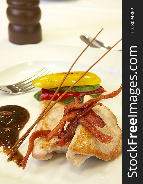 Main dish of pork with grilled vegetables and berries sauce
