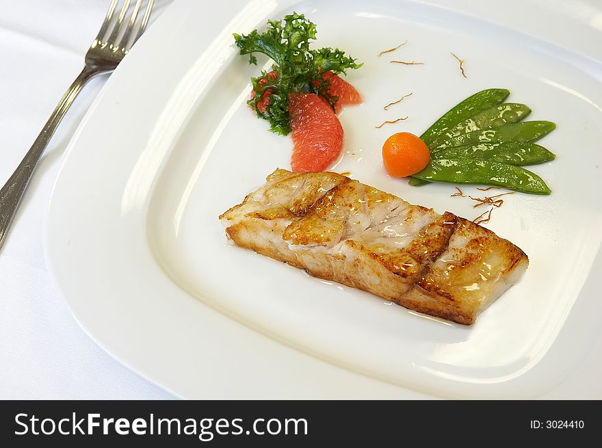 Slice of a grilled salmon with vegetables