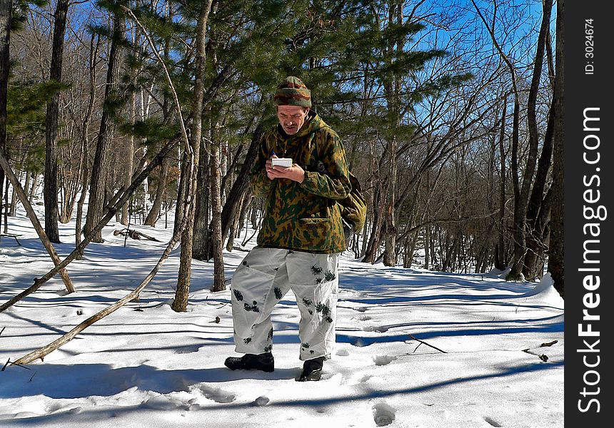 The scientist is on count of amure tiger in far-eastern taiga. Russian Far Easr, Primorye, nature state reserve Lazovsky. The scientist is on count of amure tiger in far-eastern taiga. Russian Far Easr, Primorye, nature state reserve Lazovsky.