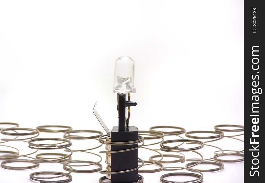 An isolated close-up photo of a small lamp and springs. An isolated close-up photo of a small lamp and springs