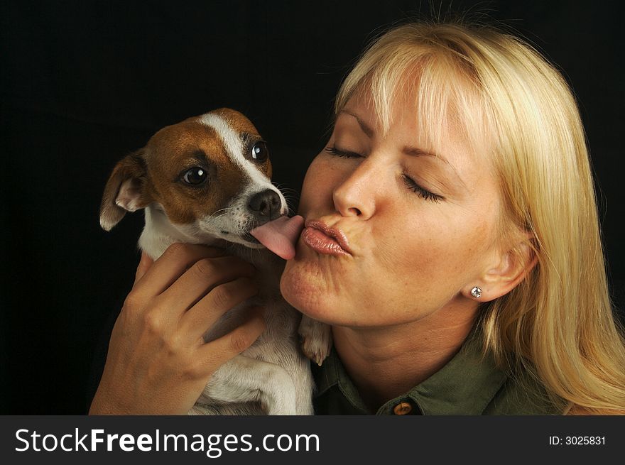 Attractive Woman Holds Her Jack Russell Terrier Dog on a Black Background. Attractive Woman Holds Her Jack Russell Terrier Dog on a Black Background