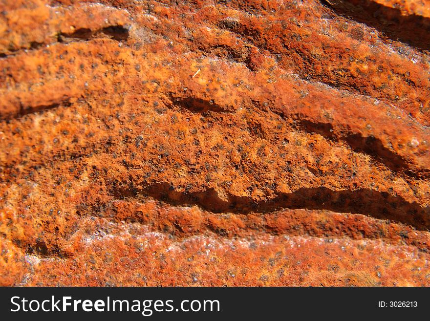 Close up of a rusty plaque with deep wrinkles